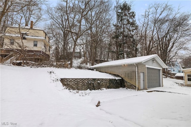 yard covered in snow with a garage