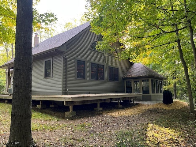 view of side of home featuring a wooden deck