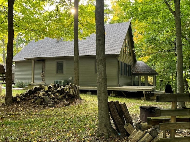 view of side of home featuring a wooden deck