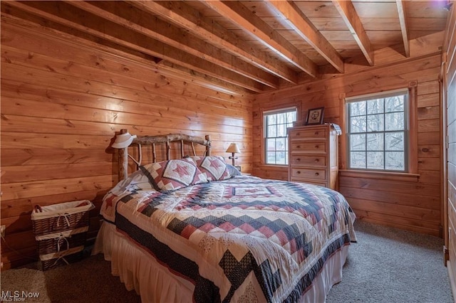 carpeted bedroom featuring beam ceiling, wood walls, and wooden ceiling