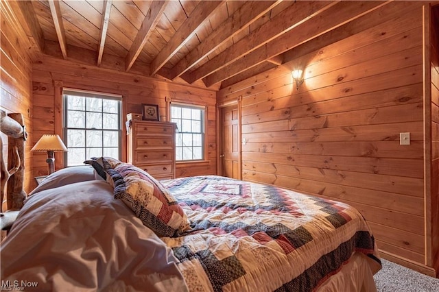 carpeted bedroom featuring beamed ceiling, wood walls, and wooden ceiling