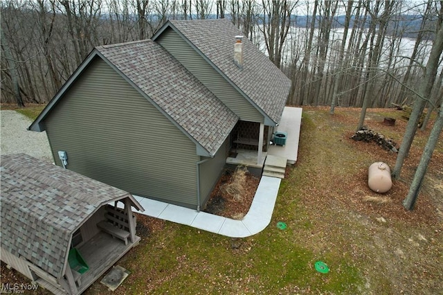 view of home's exterior featuring a lawn and an outbuilding