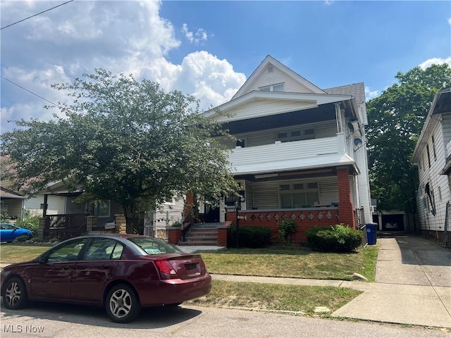 view of front facade with a front yard and a porch