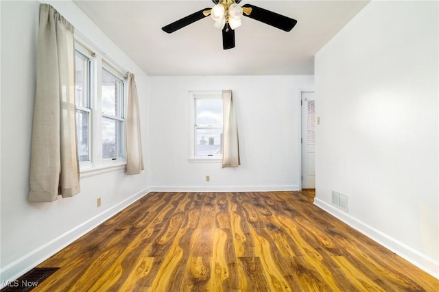 empty room featuring ceiling fan and dark hardwood / wood-style flooring