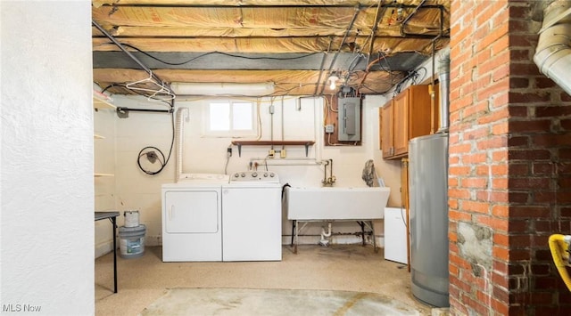 basement featuring electric panel, washer and clothes dryer, gas water heater, and sink