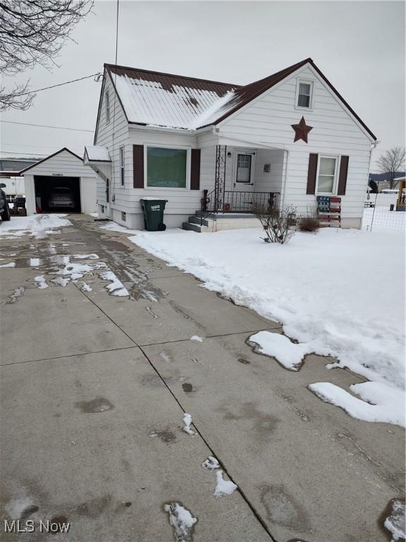 view of front of house featuring a garage and an outdoor structure