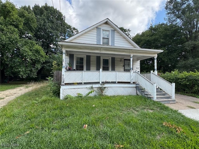 view of front of home with a porch and a front lawn