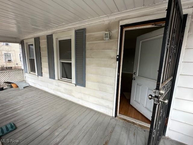 view of exterior entry with covered porch