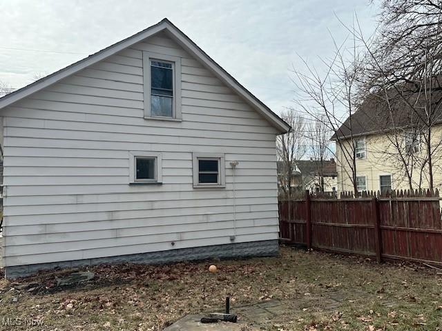 view of home's exterior featuring fence