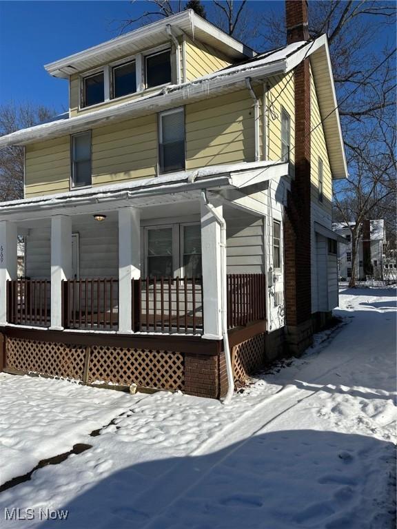 exterior space featuring a porch and a garage