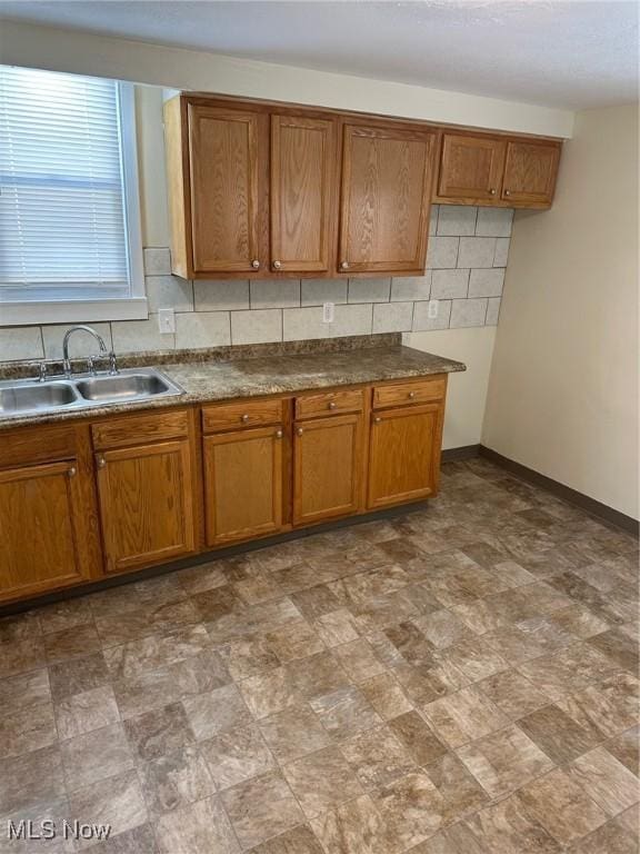 kitchen with tasteful backsplash and sink