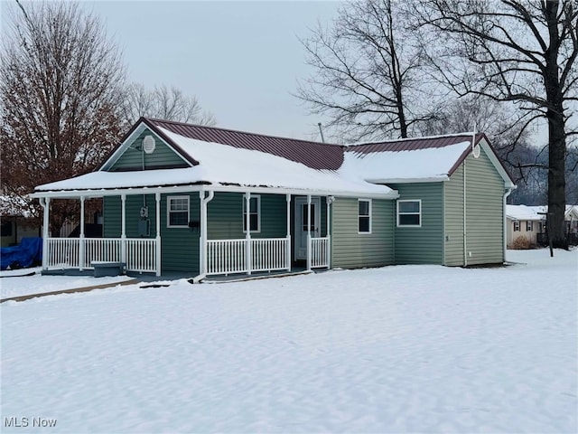 view of snow covered rear of property