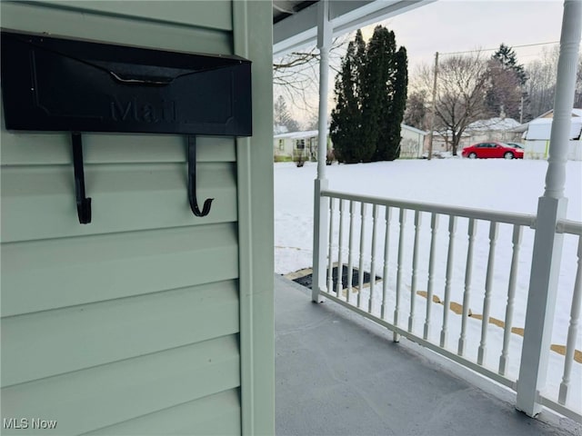 view of snow covered back of property