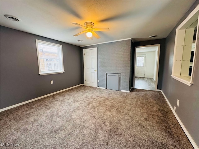 unfurnished bedroom with ceiling fan, carpet floors, and multiple windows