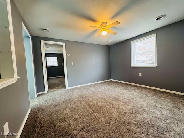 spare room with carpet and ceiling fan