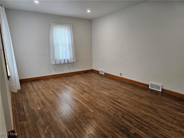 spare room with dark wood-type flooring