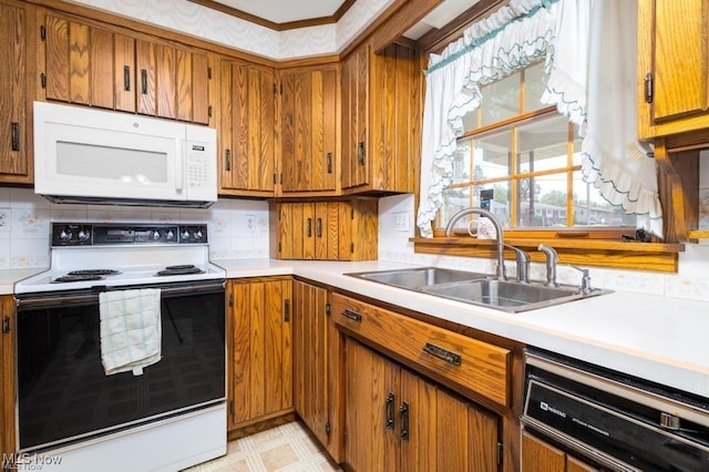 kitchen with white appliances, tasteful backsplash, and sink