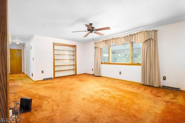 unfurnished room with ceiling fan and light colored carpet