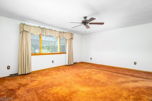 spare room with ceiling fan and carpet