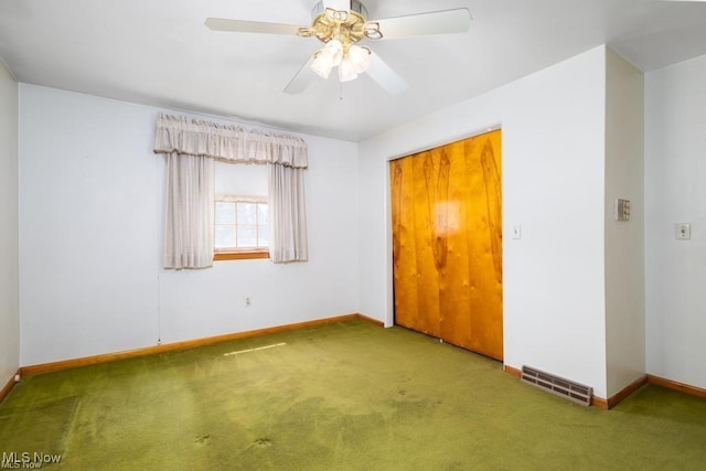 empty room featuring carpet and ceiling fan