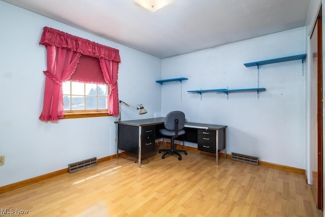 office with light wood-type flooring