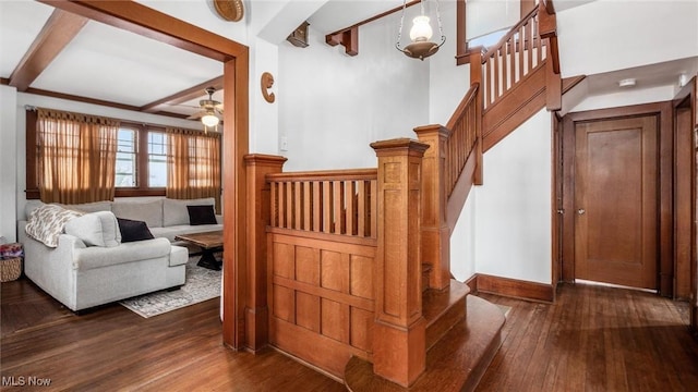 stairway with beam ceiling, hardwood / wood-style flooring, and ceiling fan