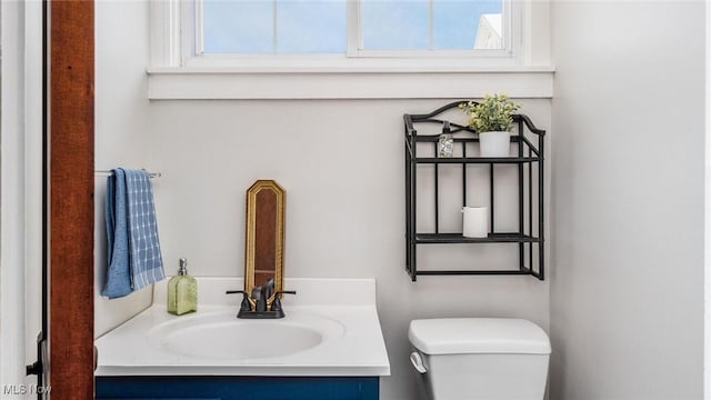 bathroom featuring vanity, toilet, and a wealth of natural light