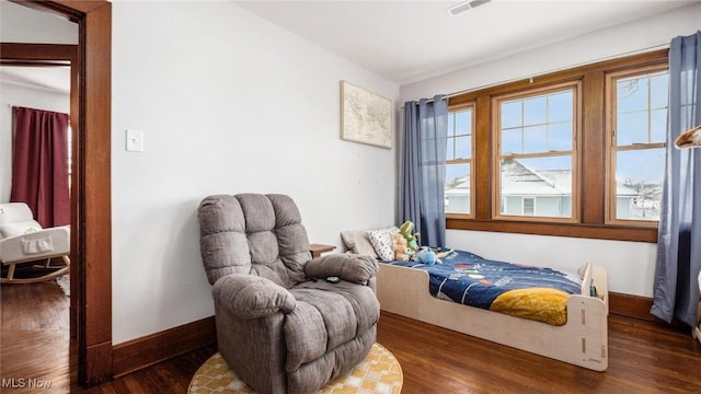 sitting room featuring a healthy amount of sunlight and dark wood-type flooring