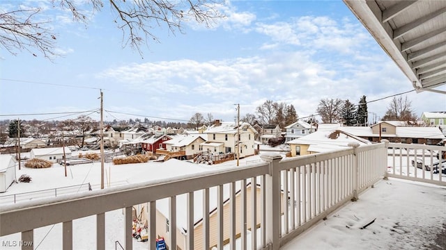 view of snow covered back of property