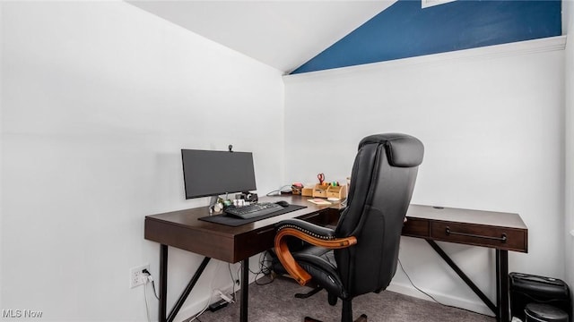 carpeted office space featuring vaulted ceiling