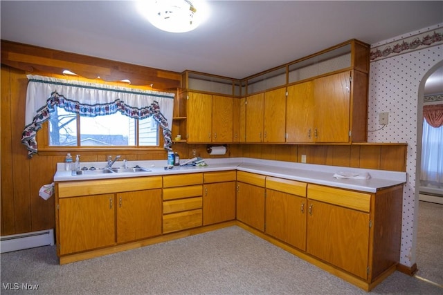 kitchen with a baseboard radiator, sink, and light colored carpet