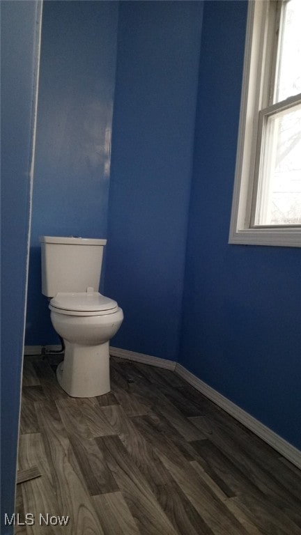 bathroom with hardwood / wood-style flooring, toilet, and plenty of natural light