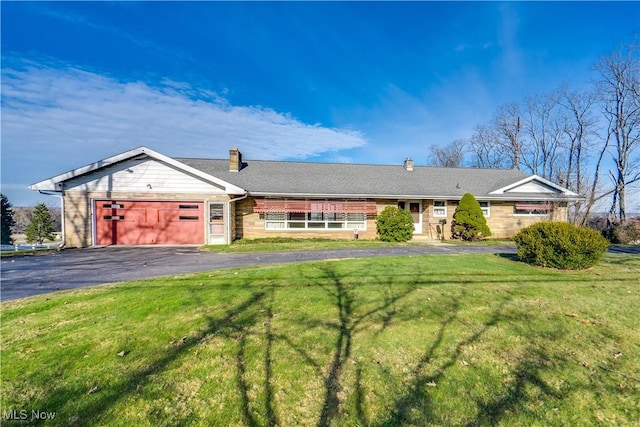 single story home featuring a garage and a front yard