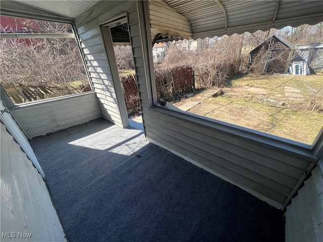 sunroom / solarium featuring vaulted ceiling