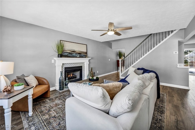 living room featuring dark hardwood / wood-style floors and ceiling fan