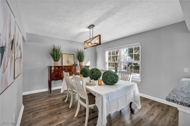 dining room featuring a textured ceiling, an inviting chandelier, and dark wood-type flooring