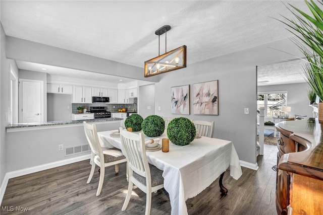 dining space featuring dark hardwood / wood-style flooring