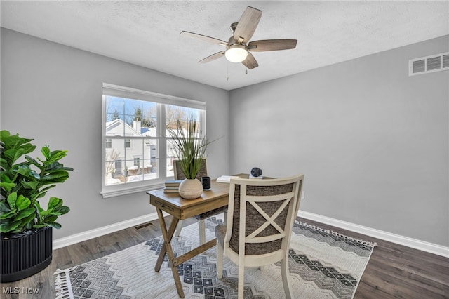 office with ceiling fan, dark hardwood / wood-style flooring, and a textured ceiling