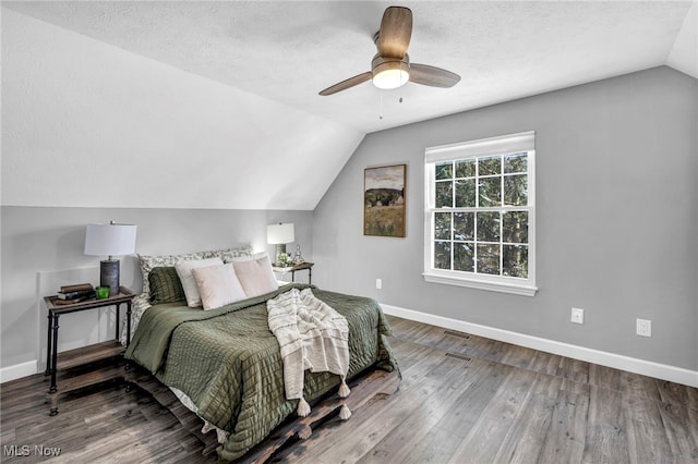 bedroom featuring hardwood / wood-style floors, ceiling fan, a textured ceiling, and vaulted ceiling