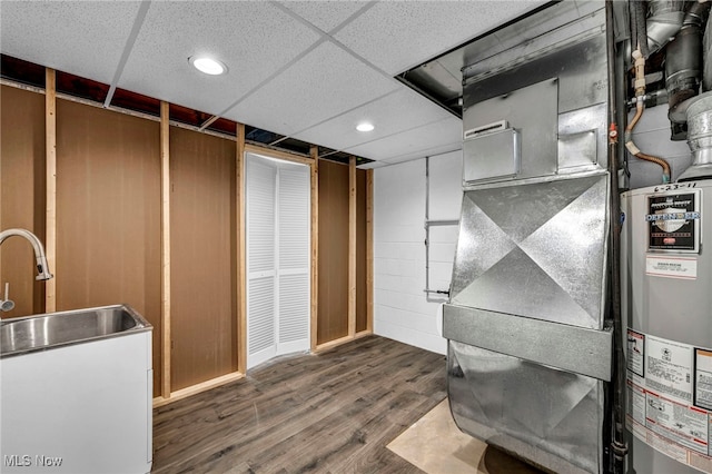 utility room featuring heating unit and sink