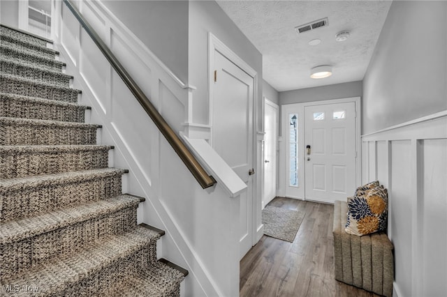 foyer with a textured ceiling and hardwood / wood-style flooring