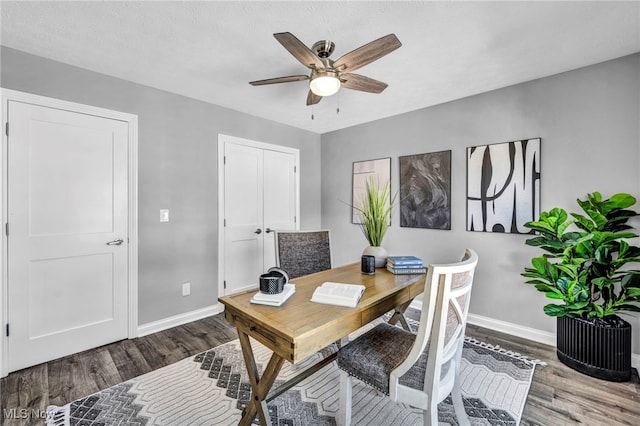 home office featuring wood-type flooring and ceiling fan