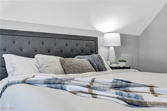 bedroom featuring lofted ceiling