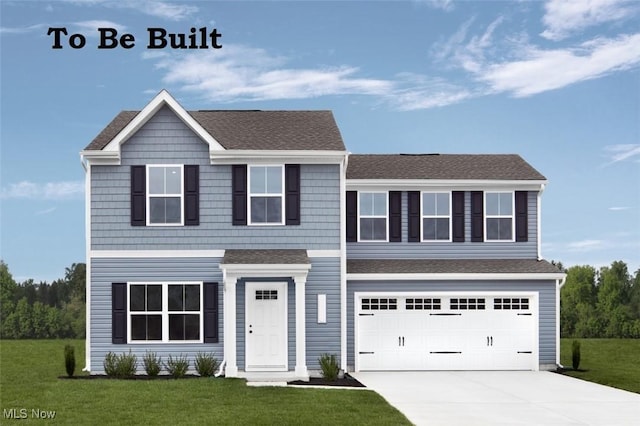 view of front of home with a garage and a front yard