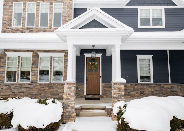 view of snow covered property entrance