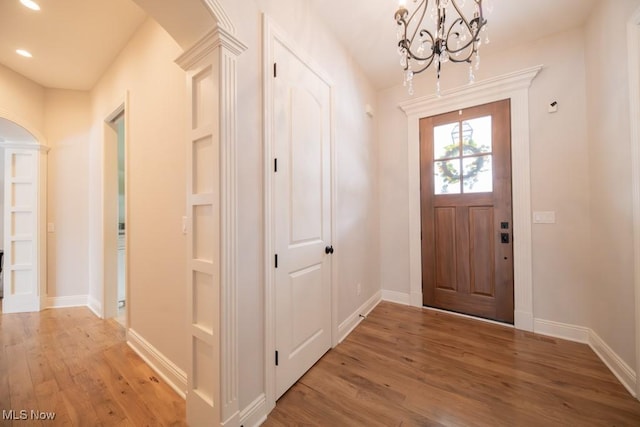 foyer with a chandelier and hardwood / wood-style flooring