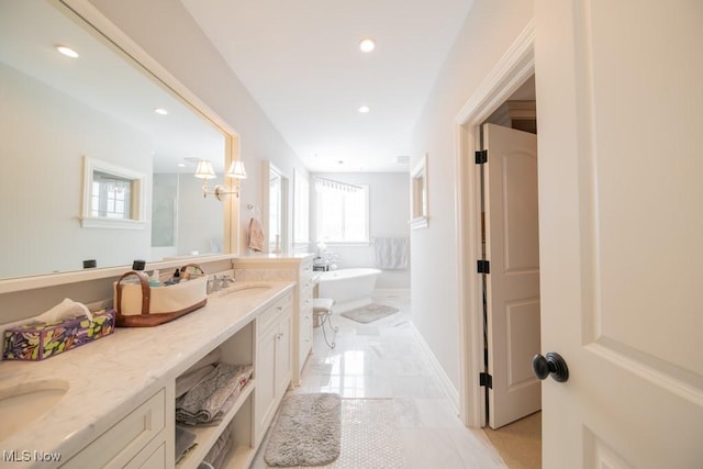 bathroom featuring vanity and a tub to relax in