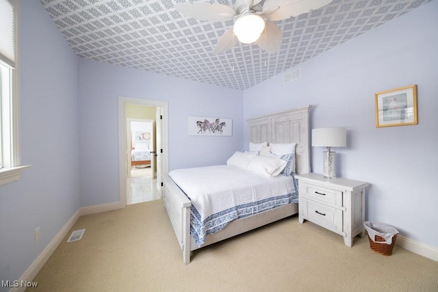 bedroom featuring light colored carpet and ceiling fan