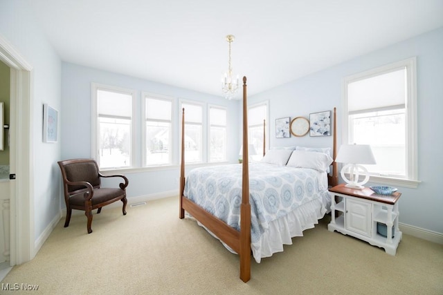 bedroom featuring light carpet and a chandelier