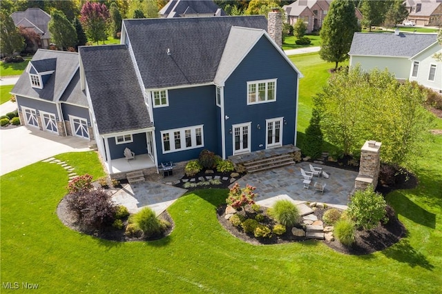 back of property featuring a yard, a patio, and french doors